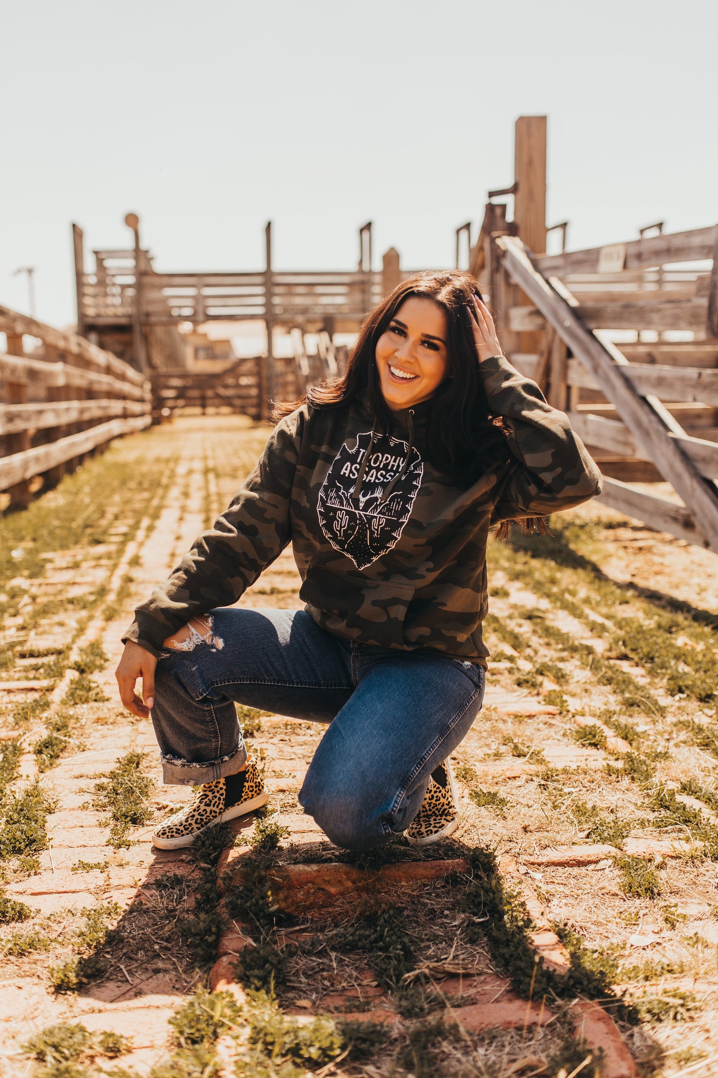 Green camo hoodie with arrowhead design and buck logo